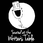 SEATED AT THE WRITER'S TABLE