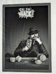 TIC TAC WHACK WITH AN EXCLAMATION POINT MADE OUT OF A DOLLAR BILL.  THERE IS A DOLLAR SIGN BETWEEN THE 